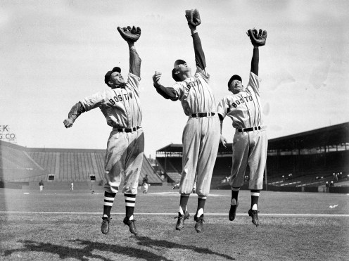 Bobby Doerr, Ted Williams, and Dom Dimaggio leap for the camera.